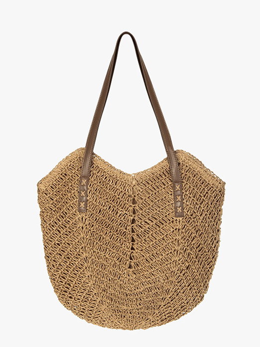 Stylish woven straw tote bag with brown leather handles on white background