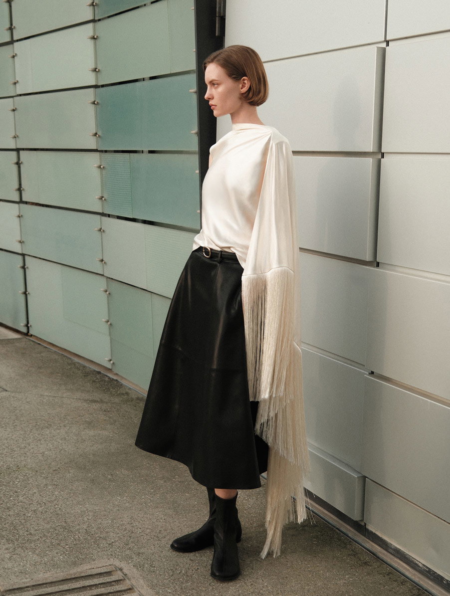 A picture of a woman wearing the Cream Satin Fringed Scarf Top