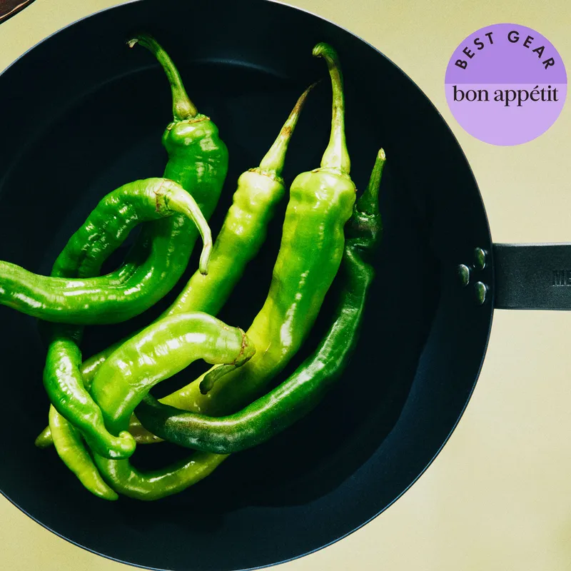 A Merten & Storck and Smithy carbon steel pans with long-hot frying peppers.