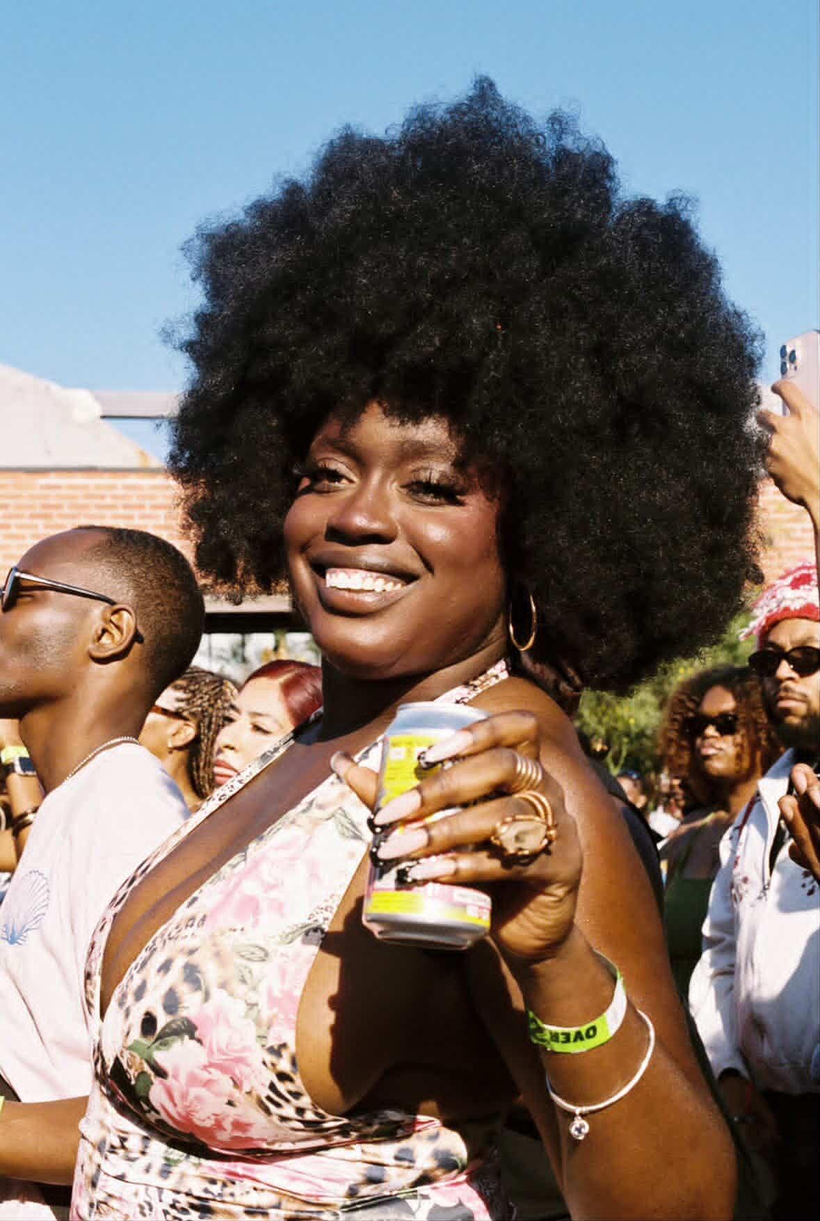 Image of woman holding Mighty Kind seltzer!