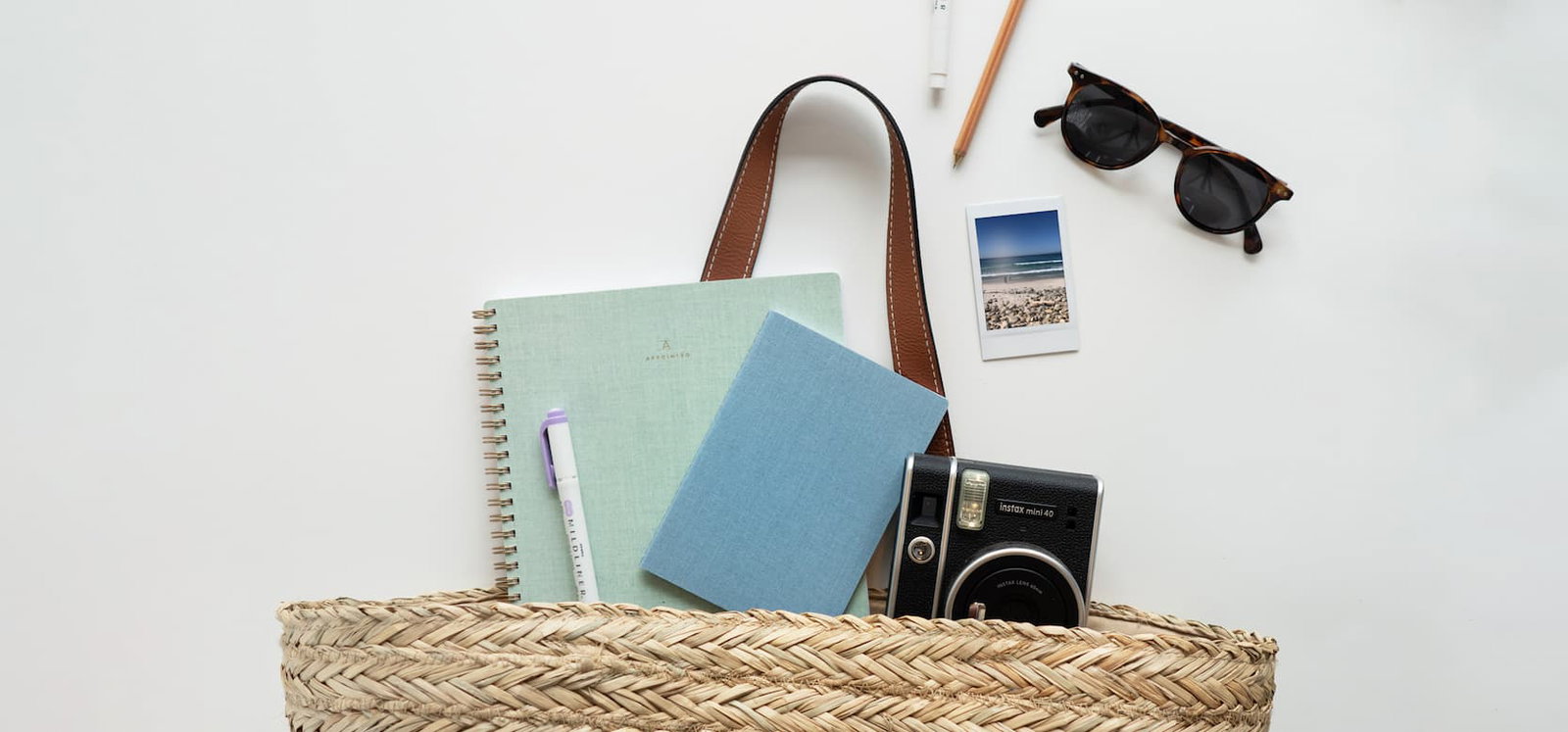 A summer bag filled with Appointed goods for getting organized.