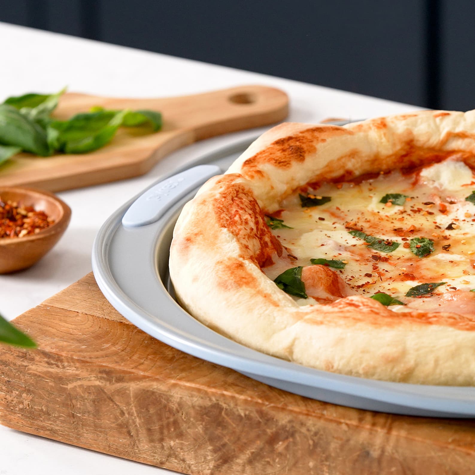 Mozzarella basil pizza with melted cheese and fresh basil on a golden crust.