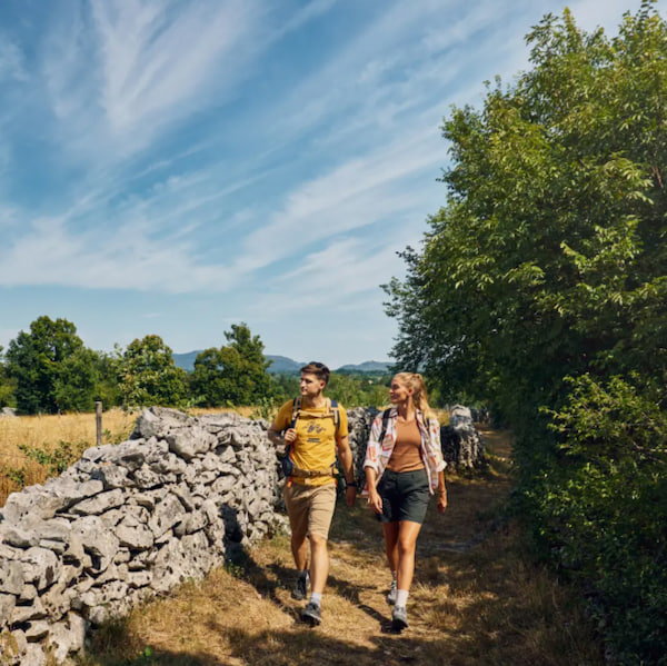 Two hikers on the Carsus Trail in Slovenia