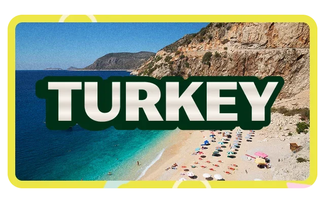 Bright yellow border frame, 'TURKEY' white bold text with dark green shadow, deep blue ocean, turquoise water, distant mountainous coastline, pristine sandy beach, colourful beach umbrellas, red blue, beach loungers, sunbathers, layered sedimentary cliff, brown tan reddish-orange rock and clear blue sky.