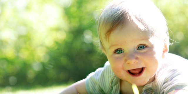 petit garçon blond dans un jardin à