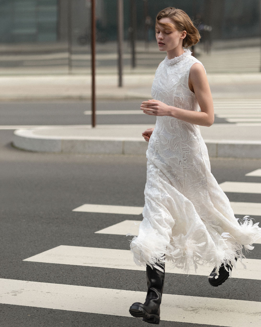 A picture of a woman in the White Sequin Lace Feather Midi Dress