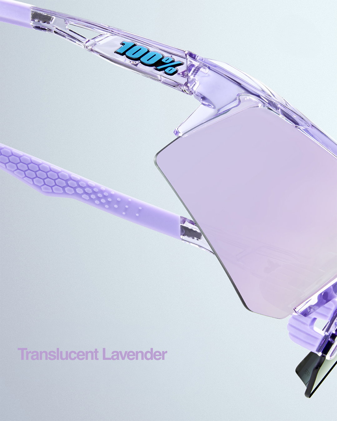 100% Speedcraft XS sunglasses in Translucent Lavender displayed from three dynamic angles against a soft gradient background, showcasing the crystal-clear purple frame and iridescent pink-to-mint mirrored shield lens.
