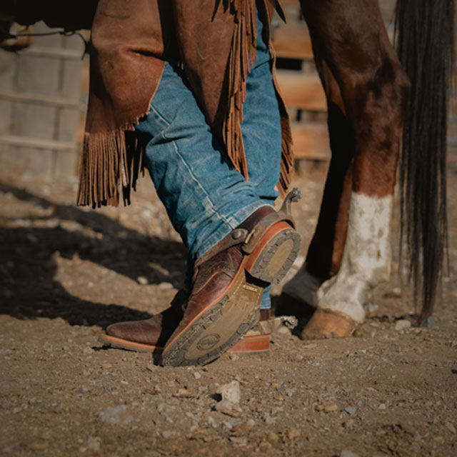 A cowboy wearing Double-H boots.