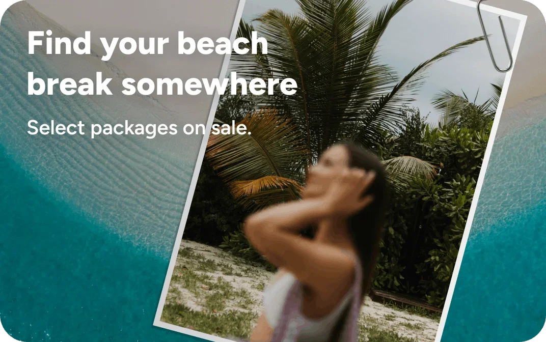 Person outside surrounded by palm trees and under the sun