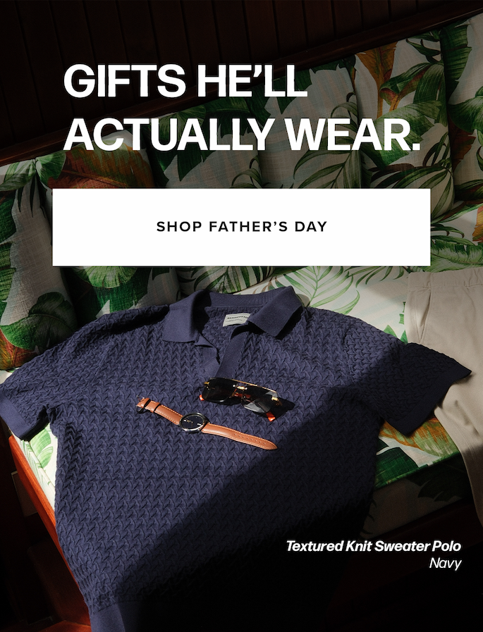 A navy knit polo, sunglasses, a watch, and cream pants rest on a palm-leaf cushion. Text reads: 'Gifts He'll Actually Wear. Shop Father's Day Textured Knit Sweater Polo Navy'