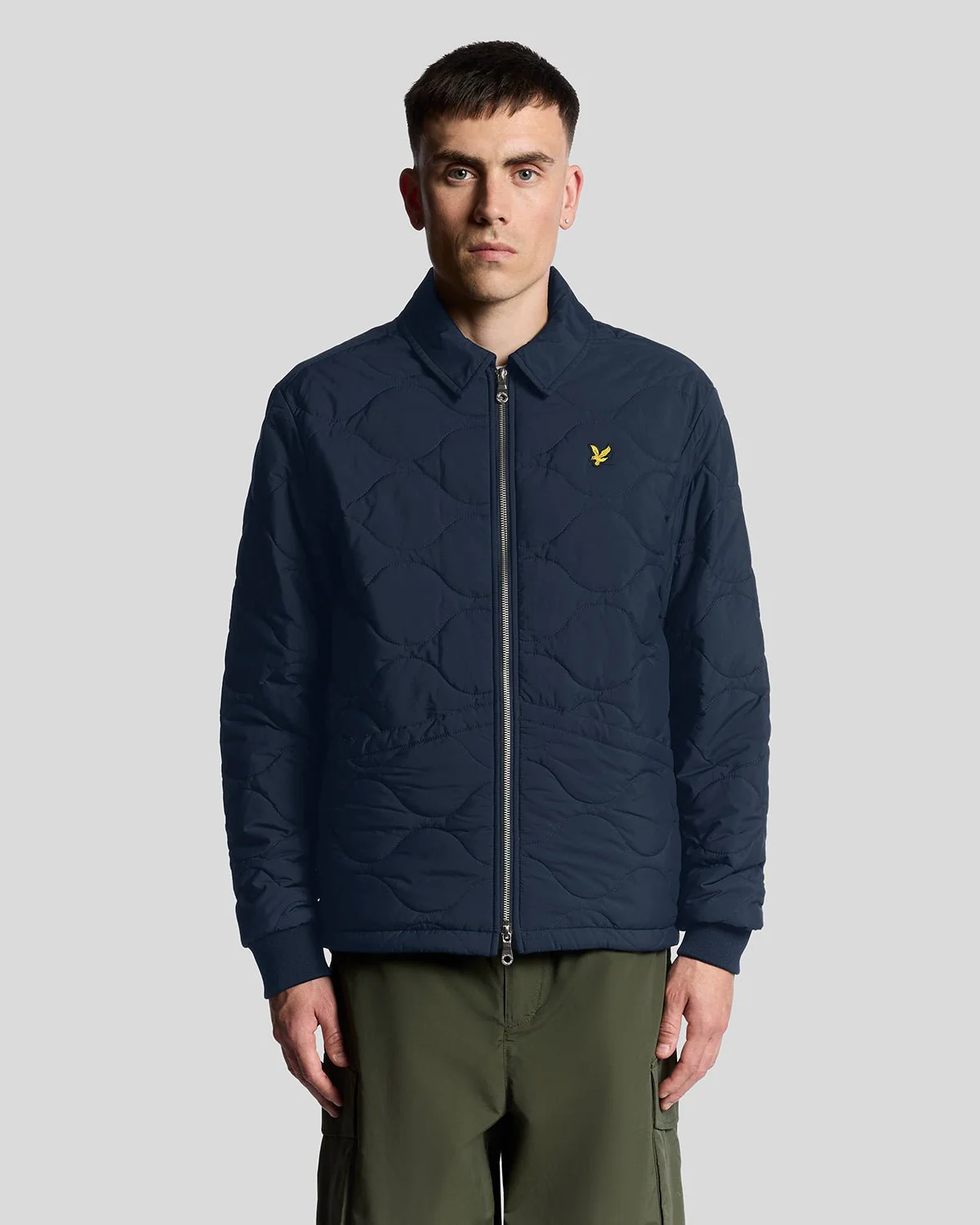 Man wears Water Resistant Ripstop Quilted Jacket in Dark Navy