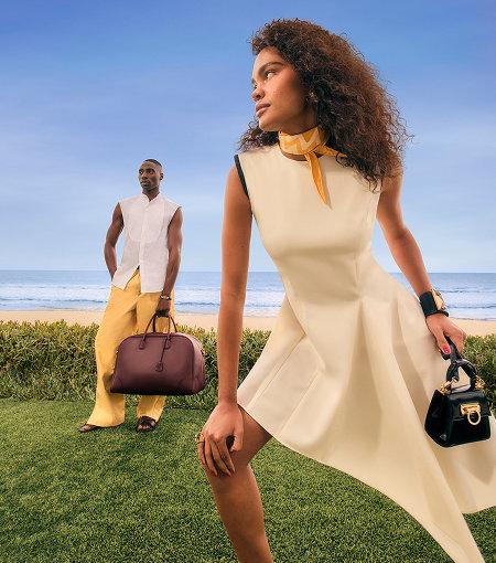 A male and female model walking wearing stylish formalwear in muted tones