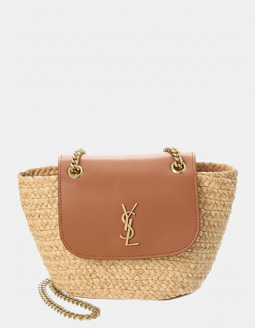 A straw tote bag with a brown leather flap and gold YSL logo.