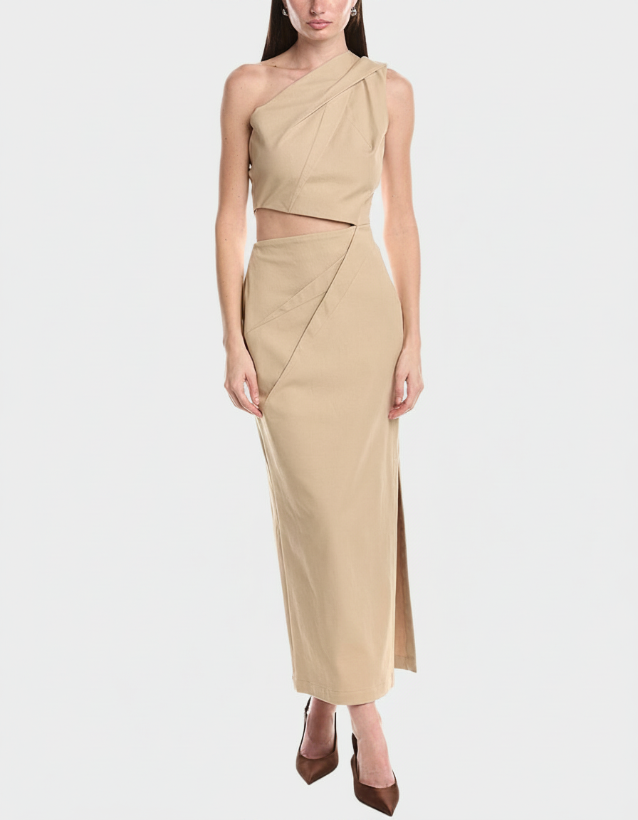 Woman in a beige one-shoulder crop top and matching maxi skirt with a slit.