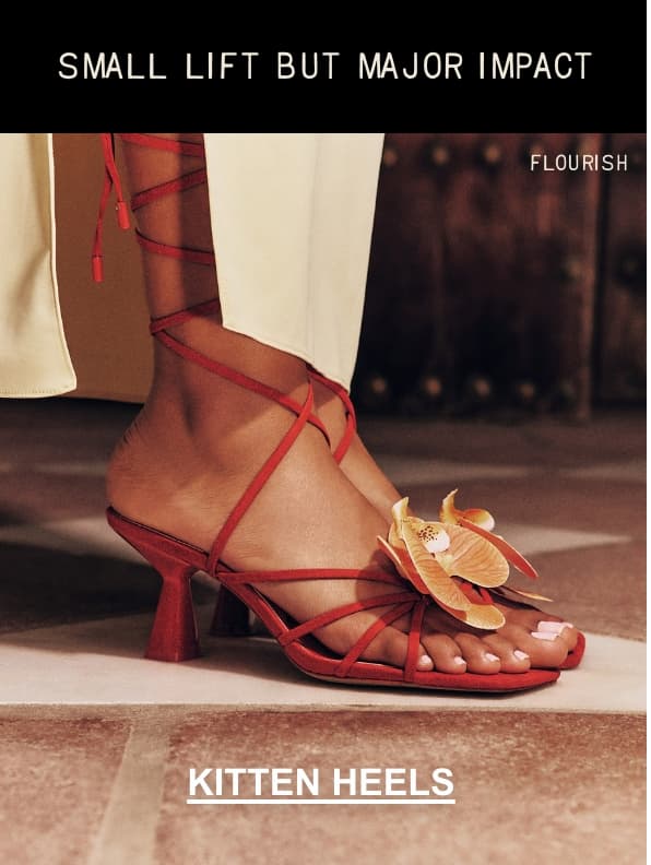 A close-up photo shows a person's foot wearing orange "FLOURISH" kitten heels with flower details. Overlaid black text at the top reads "SMALL LIFT BUT MAJOR IMPACT" and white text at the bottom reads "KITTEN HEELS".