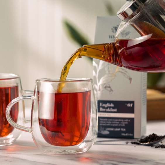 image of tea being poured into nova glass with pouch in background