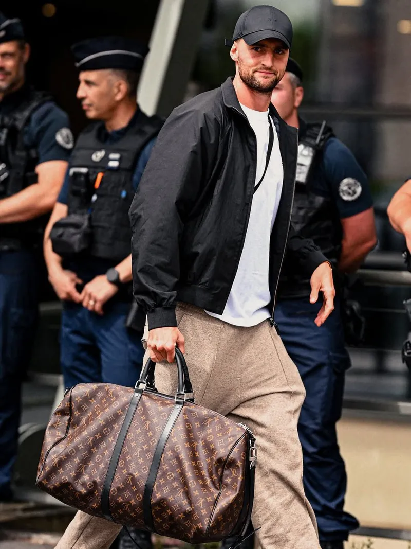 Image may contain: Adrien Rabiot, Accessories, Bag, Handbag, Adult, Person, Clothing, Hat, and Coat