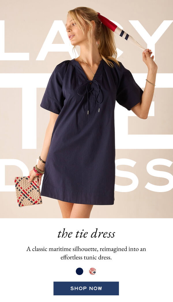 The Tie Dress - A classic maritime silhouette, reimagined into an effortless tunic dress. - Shop now - Image of a woman wearing a navy tunic dress with lace-up detail.