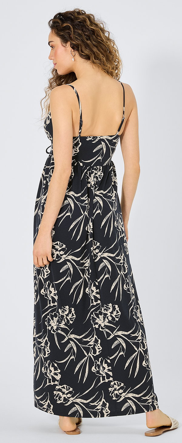 Frauenmodel trägt langes Kleid, Schwarz mit weißem Blumenmuster, Spaghettiträger, Rückansicht