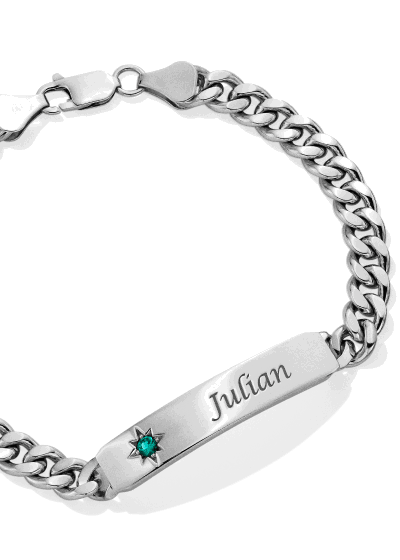 Sterling silver curb chain ID bracelet featuring engraved nameplate and green birthstone accent.