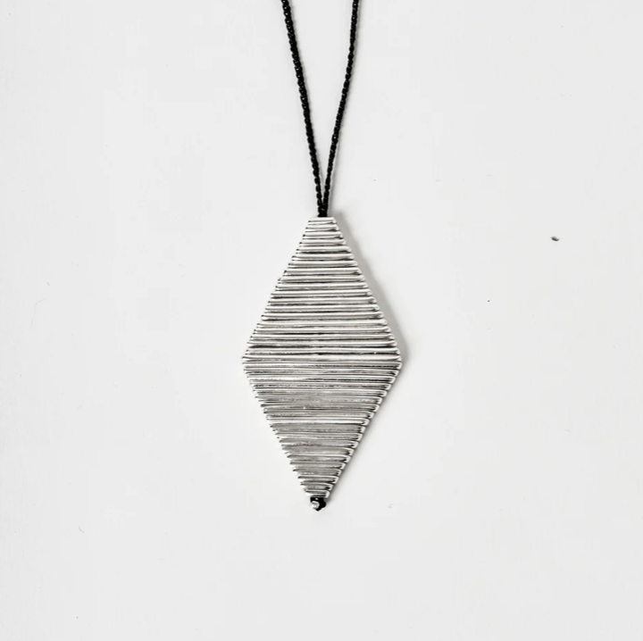 Sculptural diamond shaped pendant necklace on black cord