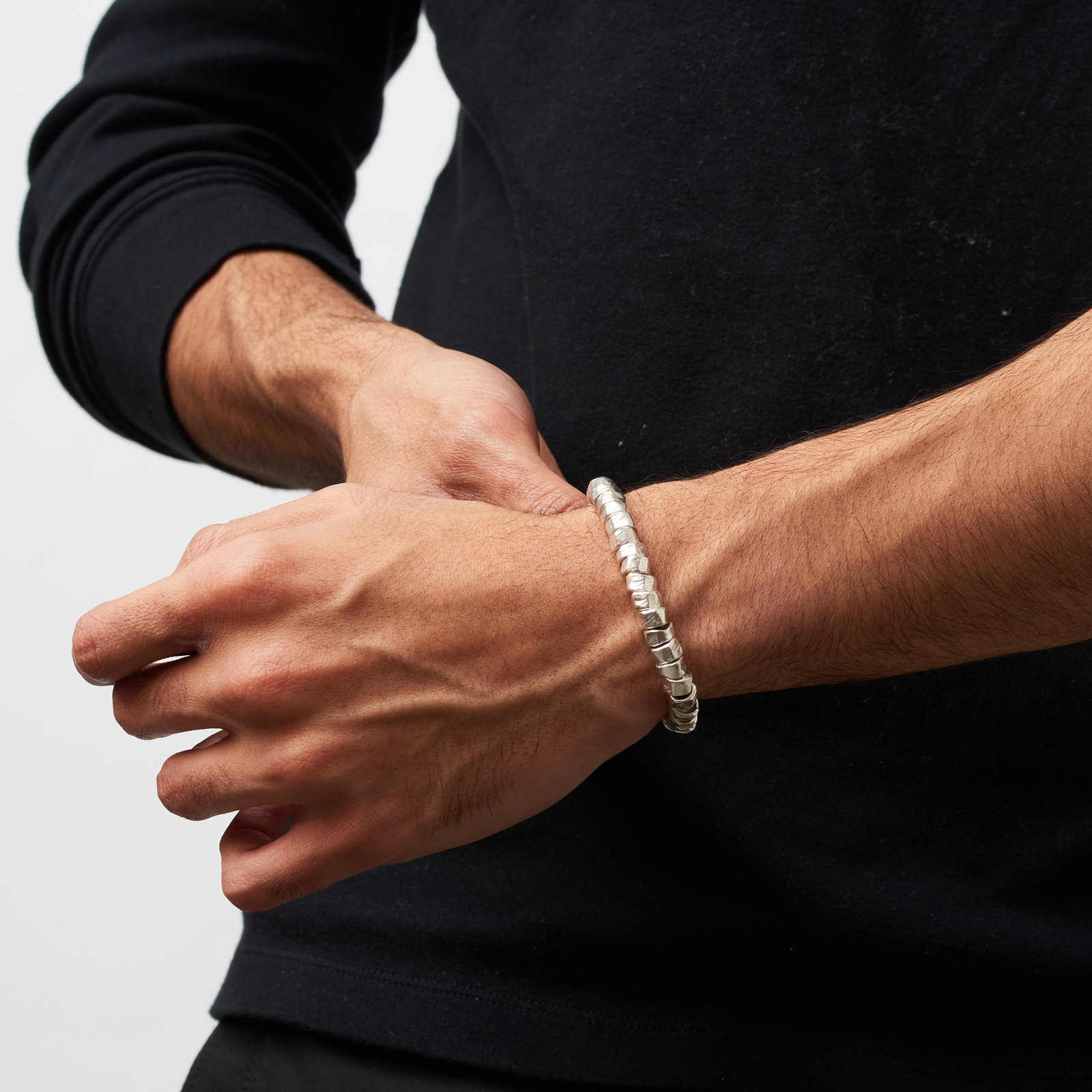 Men's wrist wearing chunky silver bracelet