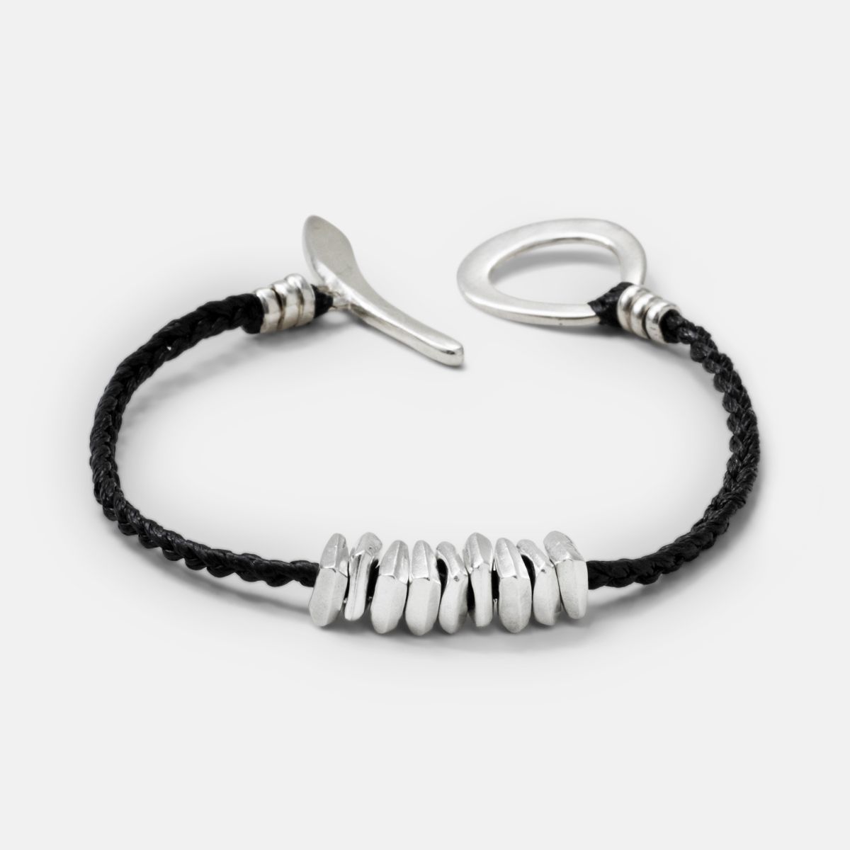 Men's black cord bracelet with silver pieces and large chunky clasp