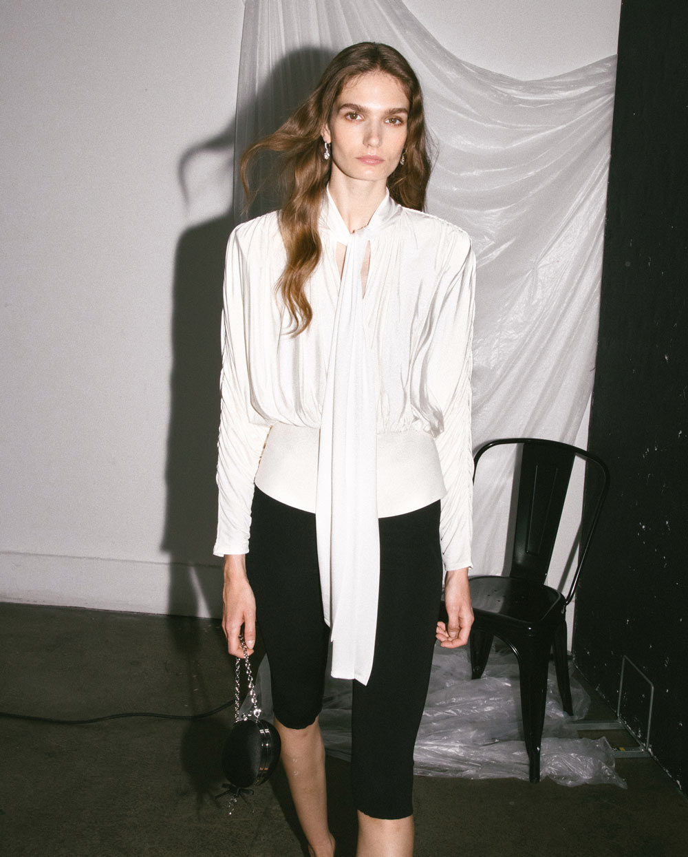 A picture of a woman wearing the Cream Tie Neck Jersey Top