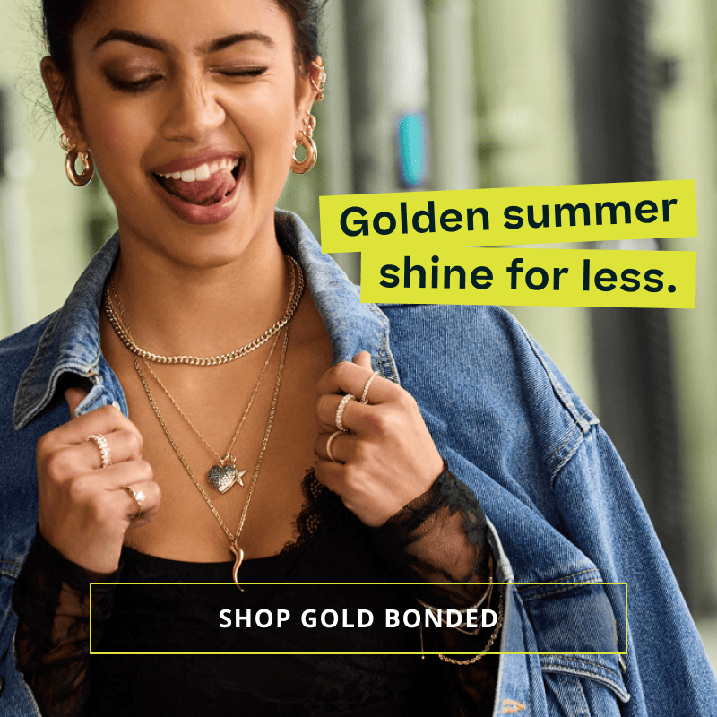 Model in gold charm chains, rings, septum & bracelets. Golden summer shine for less. Click here to shop gold bonded