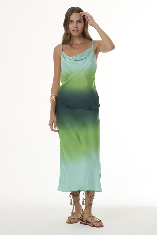 Woman wearing green ombre satin cami and matching skirt