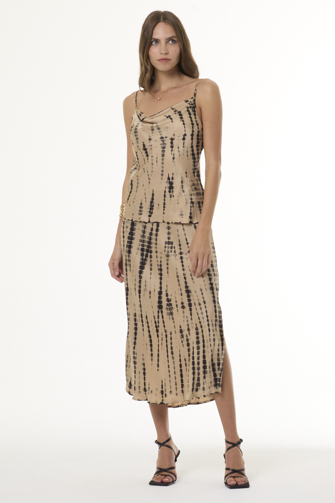 Woman wearing black and tan printed cami and matching skirt