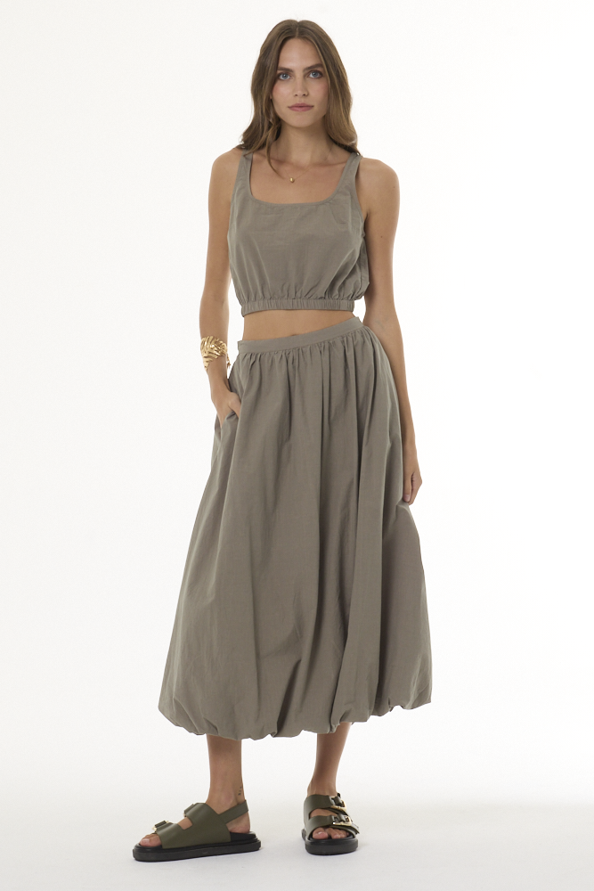 Woman wearing khaki bubble skirt and matching tank top