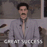 a man in a suit and tie with a mustache is standing in front of a map and says great success .