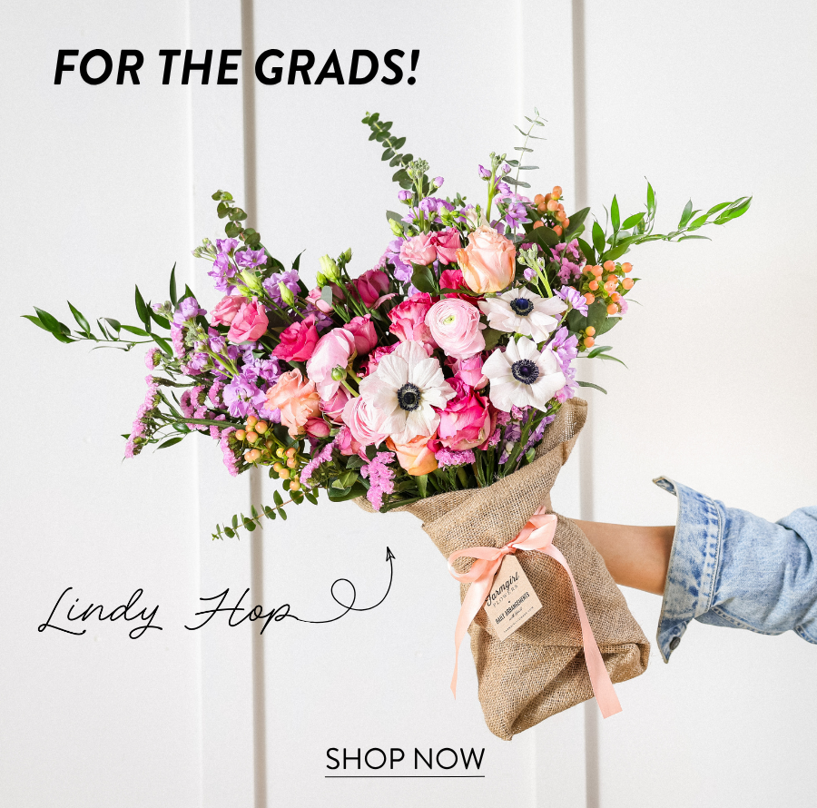Product feature for “Lindy Hop,” showing a colorful burlap-wrapped bouquet with pink, peach, purple, white, and green flowers held out by someone in a denim sleeve. Text reads “For the Grads!” with a “Shop Now” link.