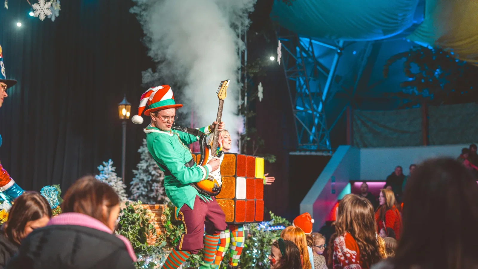 Elf playing the guitar on stage at the Jingle Jive end of stay party