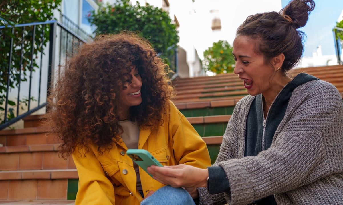 Two women looking at phone