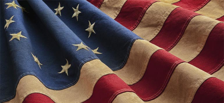 A close-up of a folded American flag showing its stars on a blue field and red and white stripes.