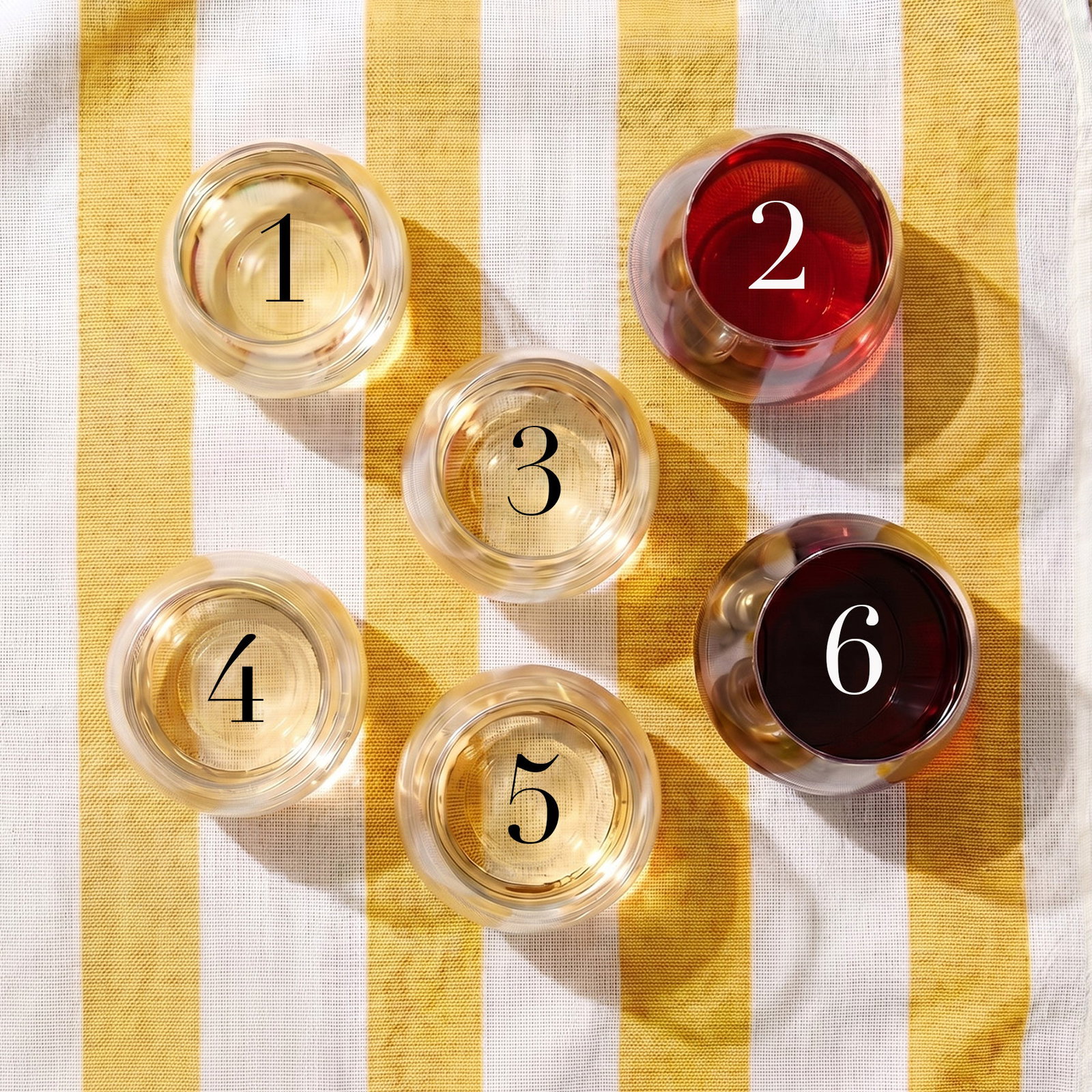 6 glasses on beach towel