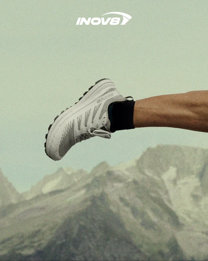 A runner wearing grey TRAILFLY ZERO V2 shoes