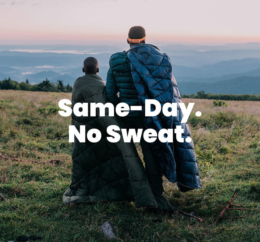 Son & father wear Rumpl blankets as they gaze at distant hilltops
