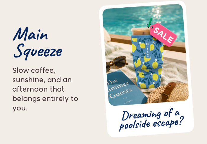 Patterned iced coffee tumbler by the pool with a book and a “Sale” tag.