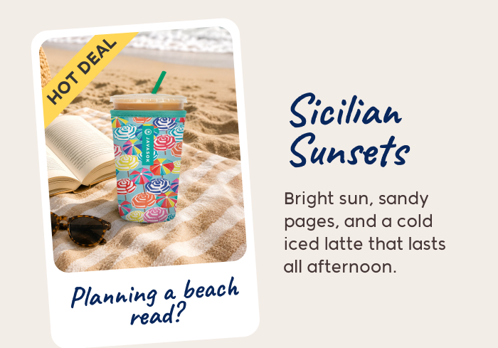 Patterned iced coffee tumbler on a beach blanket beside a book with a “Hot Deal” tag.