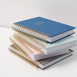 stacked bookcloth planners in assorted colors