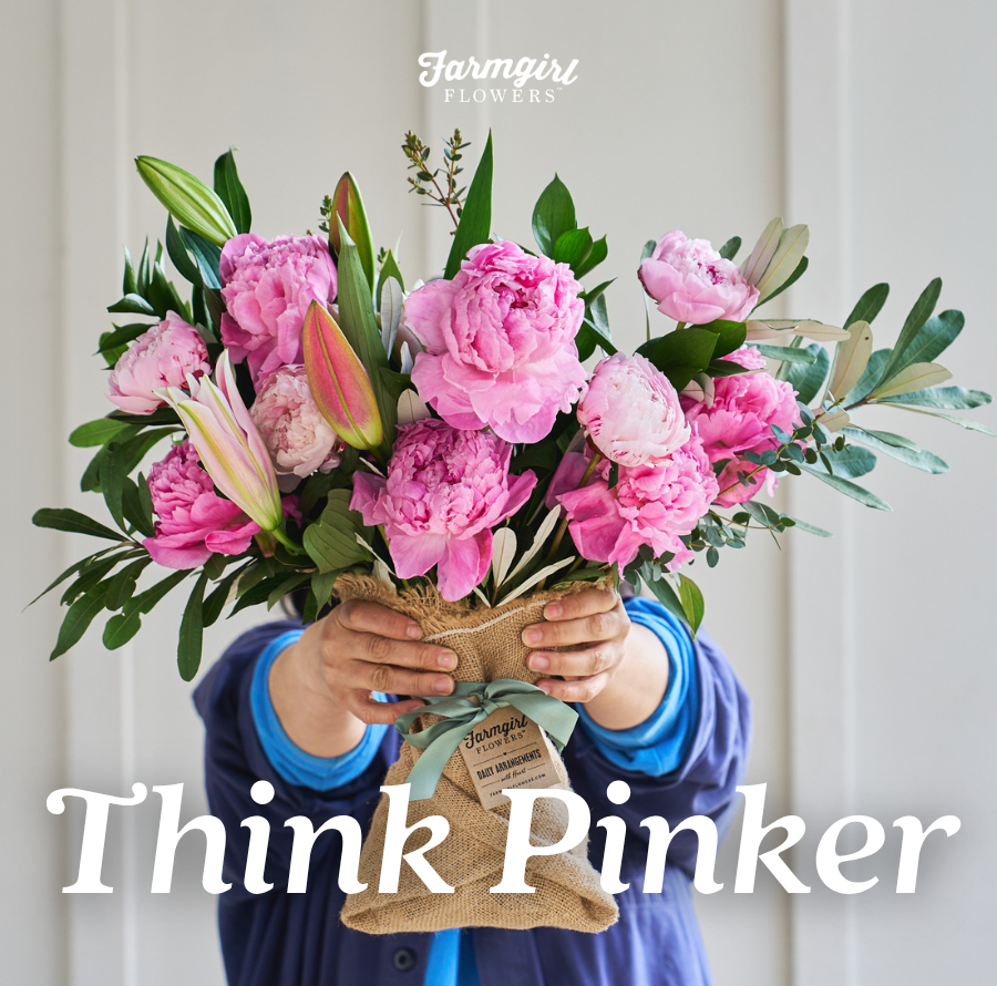 A person holds up a burlap-wrapped bouquet of bright pink peonies and lilies, hiding their face behind the flowers. Text reads: Think Pinker.