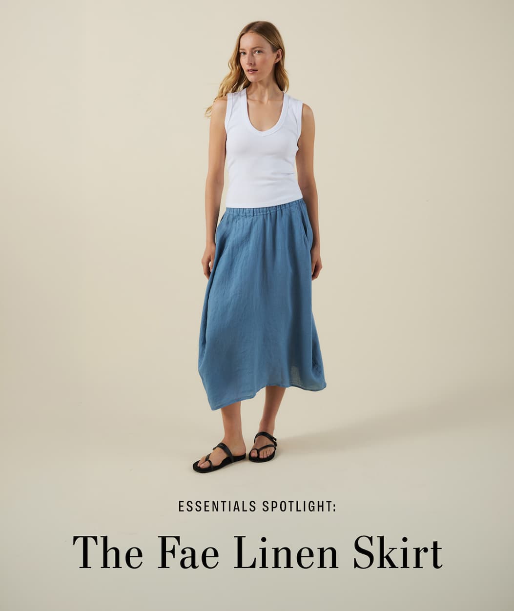 Image shows a model wearing the Fae Skirt in Hailstone. Text reads: Essentials Spotlight: The Fae Linen Skirt
