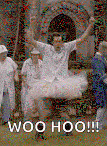 a man is wearing a tutu and jumping in the air in front of a group of people .