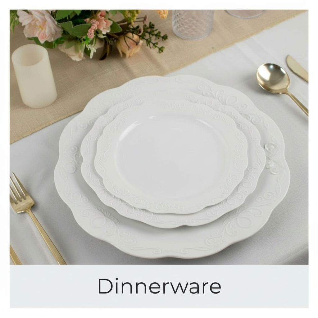 Stack of white decorative plates with gold cutlery and flowers on a table.