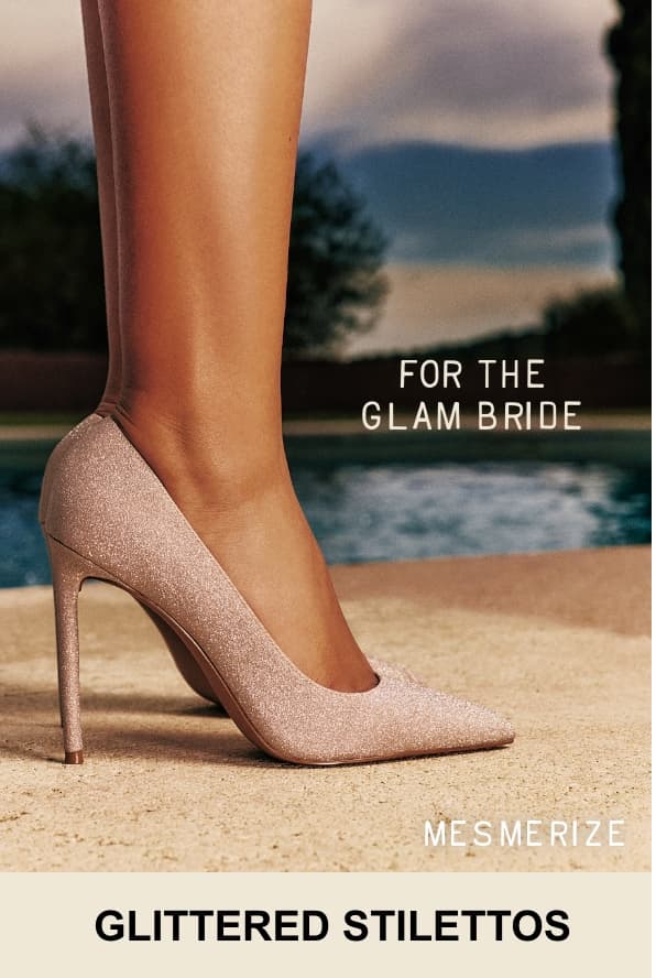 A close-up photo shows a person's foot wearing a glittery beige "MESMERIZE" stiletto pump by a swimming pool. Overlaid white text at the top reads "FOR THE GLAM BRIDE", and the bottom text reads "GLITTERED STILETTOS".