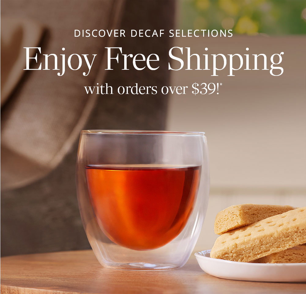 Decaf black tea in a teacup with shortbread cookies on a small white plate next to it in a living room setting.