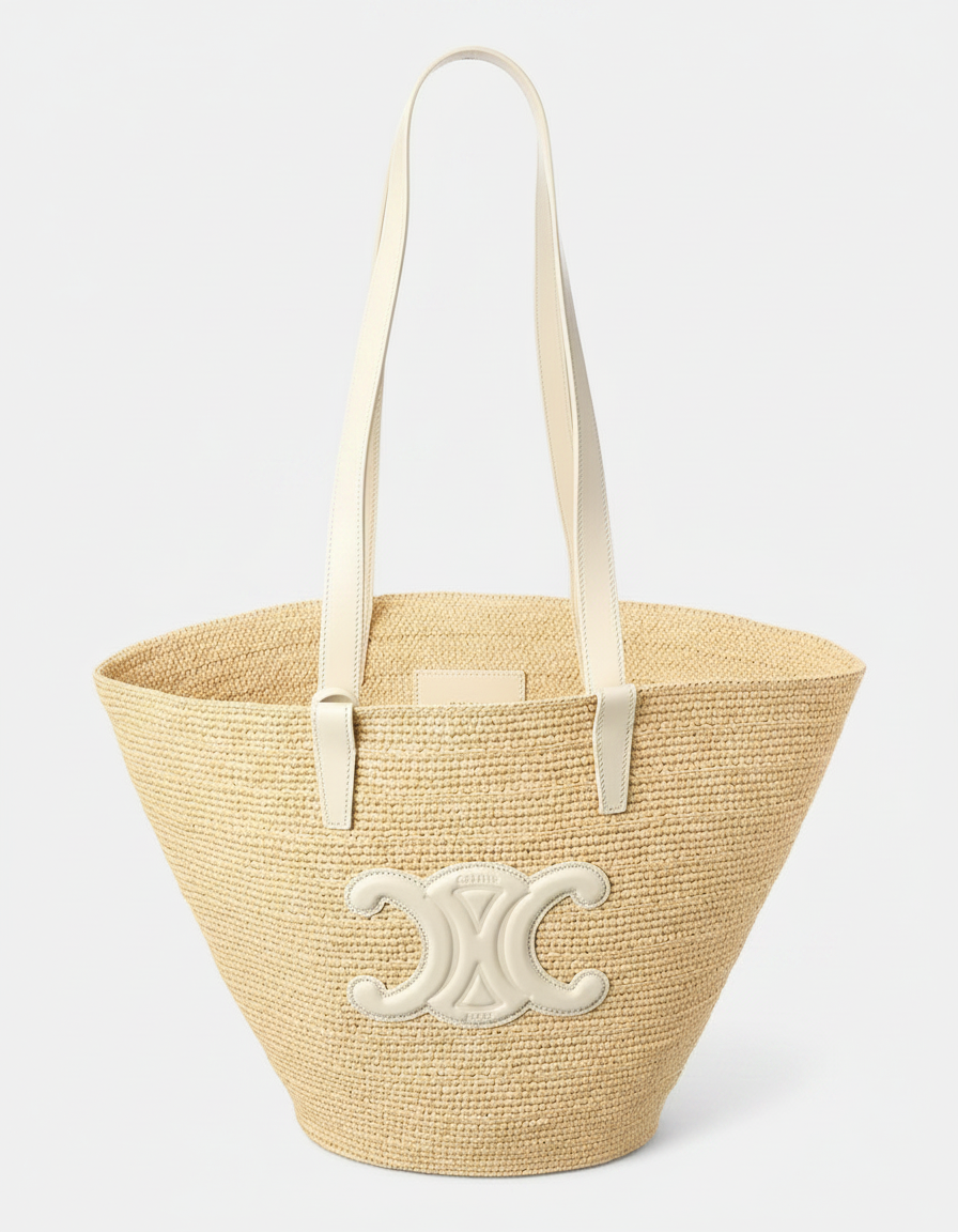 A straw tote bag with white leather straps and a white logo emblem.